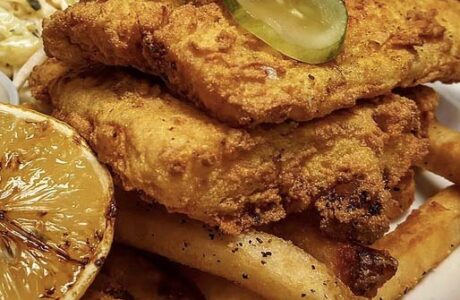 golden fried cod and chips on a plate