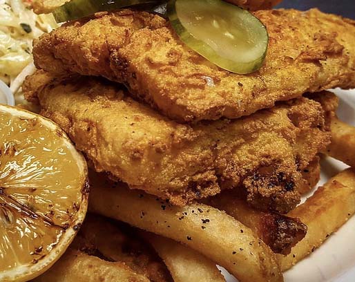 golden fried cod and chips on a plate