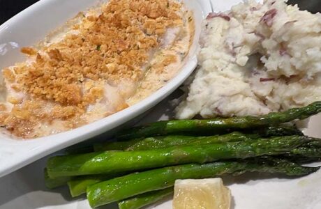 casserole dish on a plate with mashed potatoes and green beans