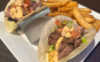 two soft flour tortillas with a steak and aioli filling