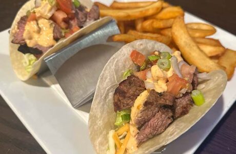 two soft flour tortillas with a steak and aioli filling