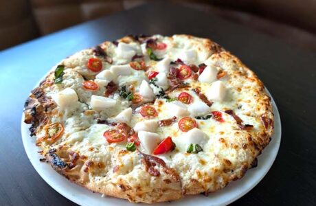 scallop and bacon pizza ready to be served